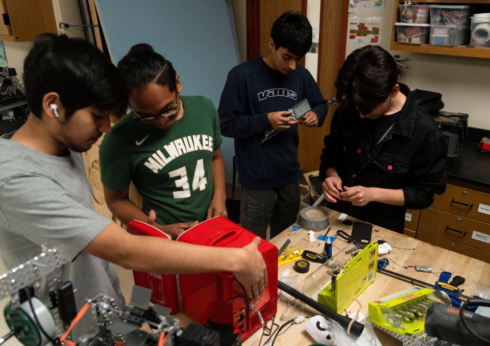 Students in Hutto High School's award-winning robotics program build a tiny fridge last week. The class operates out of converted rooms that aren’t ideal for building machines, said Andrew Haub, the district's lead robotics instructor.