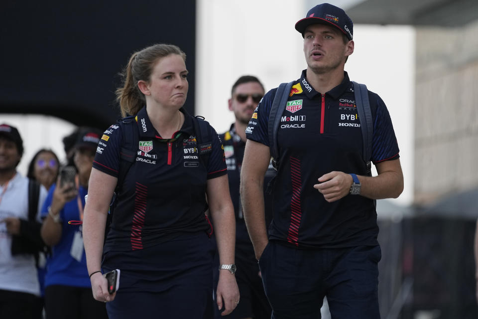 Red Bull driver Max Verstappen of the Netherlands, right, walks through the paddock at the Lusail International Circuit, Lusail, Qatar, Thursday, Oct. 5, 2023. The Qatar Formula One Grand Prix race will be held on Sunday. (AP Photo/Ariel Schalit)