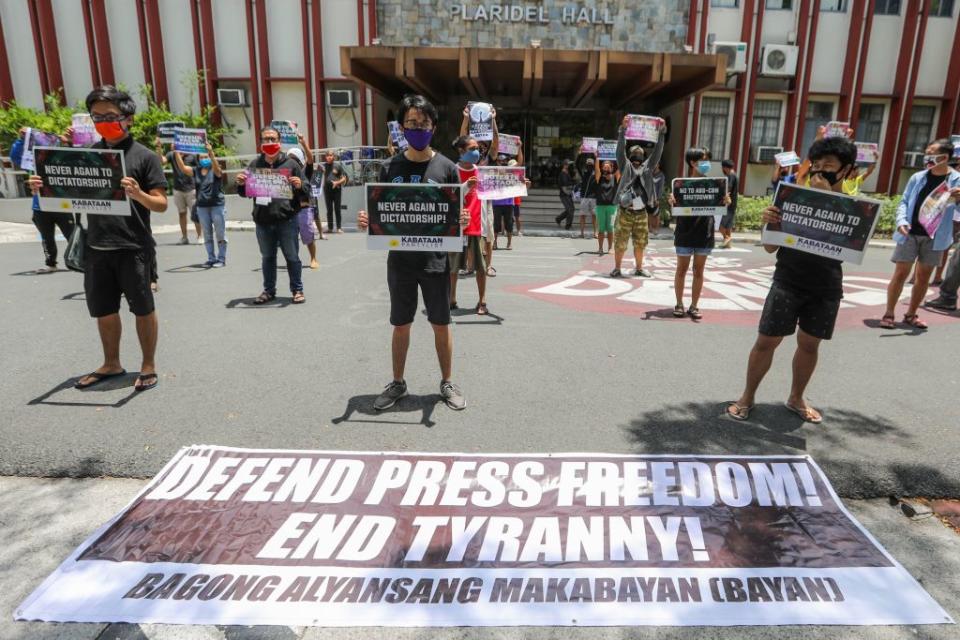 People from Bagong Alyansang Makabayan (Bayan) take part in a protest against the Philippine government-ordered shutdown of broadcaster ABS-CBN while observing social distancing outside the College of Mass Communication at the University of the Philippines in Manila on May 8, 2020.<span class="copyright">Maria Tan—AFP/Getty Images</span>