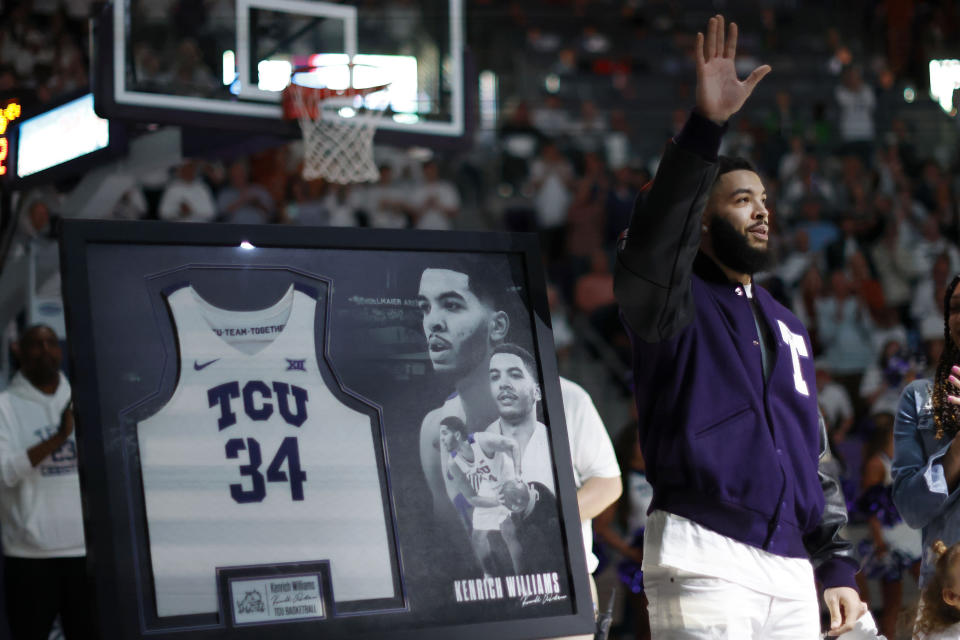 Former TCU player Kendrich Williams waves to the crowd as his jersey number is retired during halftime of an NCAA college basketball game in Fort Worth, Texas, Saturday, Feb. 3, 2024. (AP Photo/Michael Ainsworth)