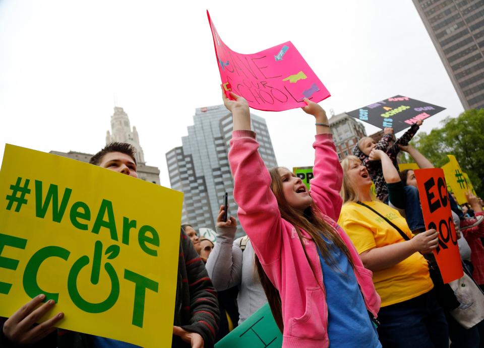 Alyssa Ruff, 10, 4th grader from Canton along with her brother Jordan, 13, 7th grader, left, cheers during an ECOT rally in May 2017. The Electronic Classroom of Tomorrow closed in 2018 and now faces legal proceedings and investigations. State Auditor Keith Faber said ECOT owes Ohio more than $117 million.