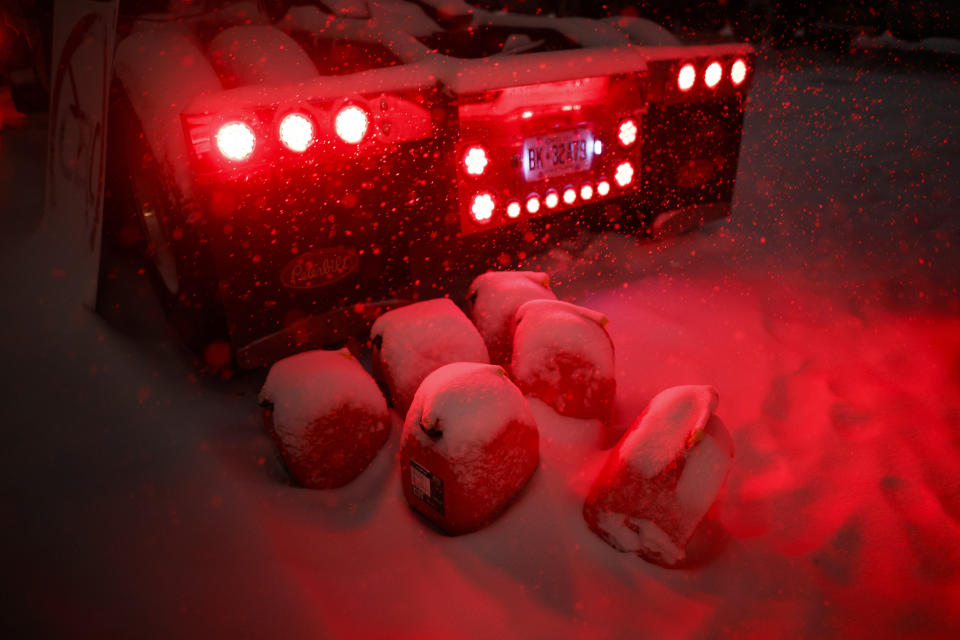 Jerrycans sit behind a truck as people gather during a protest against COVID-19 measures that has grown into a broader anti-government protest that continues to occupy downtown Ottawa, Ontario, on Thursday, Feb. 17, 2022. (Cole Burston/The Canadian Press via AP)