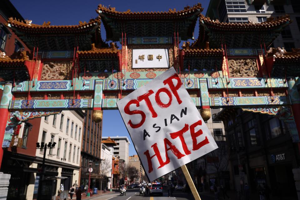 An activist holds a sign after he marched to Chinatown from a “DC Rally for Collective Safety - Protect Asian/AAPI Communities,” hosted by OCA – Asian Pacific American Advocates, at McPherson Square March 21, 2021, in Washington, DC. Activists took part in the rally in response to the Atlanta, Georgia spa shootings that left eight people dead, including six Asian women, and the rising number of attacks against Asian Americans and Pacific Islanders since the COVID-19 pandemic began in 2020.