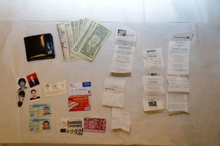 Identification, money and receipts are seen in this undated handout evidence photo provided by the U.S. Attorney's Office in Boston, Massachusetts on March 25, 2015. REUTERS/U.S. Attorney's Office/Handout