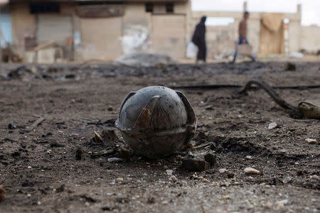 An unexploded cluster bomblet is seen along a street after airstrikes by pro-Syrian government forces in the rebel held al-Ghariyah al-Gharbiyah town, in Deraa province, Syria February 11, 2016. REUTERS/Alaa Al-Faqir/File Photo