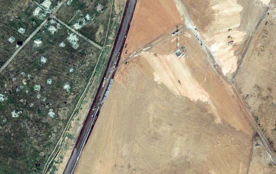 This handout satellite picture taken and released by Maxar Technologies on Feb. 15, 2024 shows machinery building a wall along the Egypt-Gaza Strip border in Rafah, Egypt. Hundreds of thousands of displaced Palestinians have been driven into Gaza's southernmost city by Israel's relentless military campaign, seeking shelter in a sprawling makeshift encampment near the Egypt border.