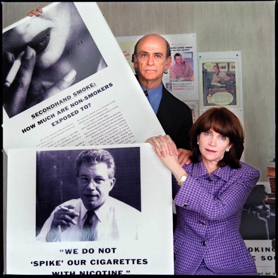 Stanley and Susan Rosenblatt pose with cigar ads on Sept. 10, 1996, while preparing for their case against major tobacco companies.