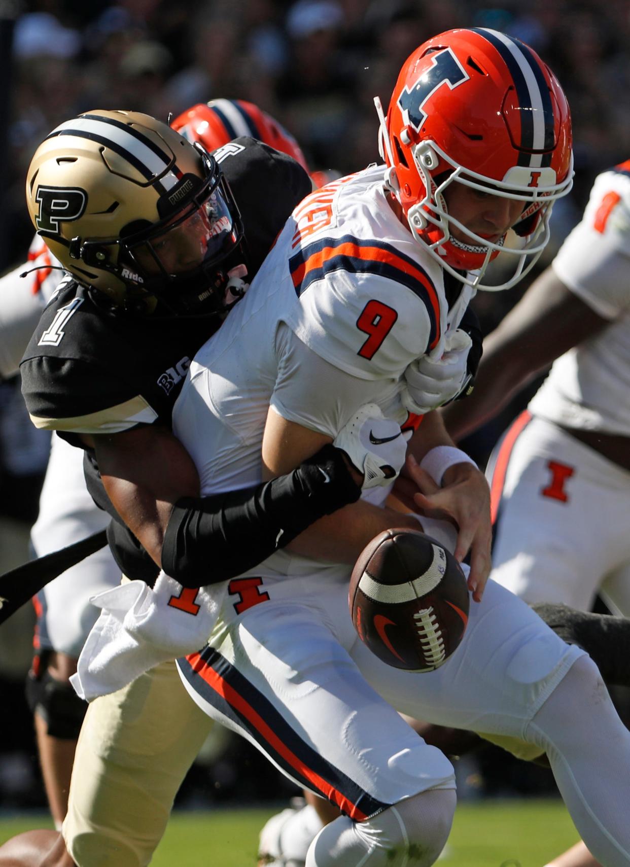 Purdue Boilermakers defensive back Markevious Brown (1) tackles Illinois Fighting Illini quarterback Luke Altmyer (9), forcing a fumble during the NCAA football game, Saturday, Sept. 30, 2023, at Ross-Ade Stadium in West Lafayette, Ind. Purdue Boilermakers won 44-19.