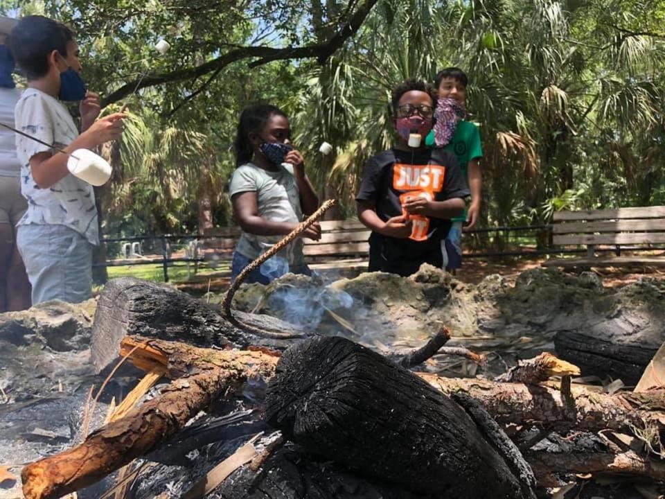 Kids enjoy toasting marshmallows over a campfire at EcoAdventures summer camp, run by Miami-Dade Parks, Recreation and Open Spaces.