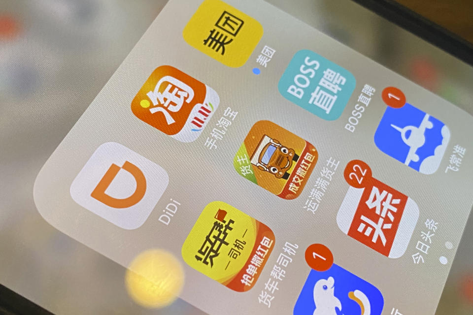 The ride-hailing app Didi is seen near other Chinese apps on a phone in Beijing on Monday, July 5, 2021. Chinese regulators have clamped down on the country’s largest ride-hailing app, Didi Global Inc., days after its shares began trading in New York. Authorities told Didi to stop new registrations and ordered its app removed from China’s app stores pending a cybersecurity review. (AP Photo/Ng Han Guan)