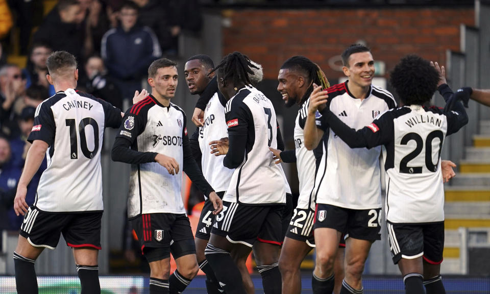 Fulham's Tosin Adarabioyo, third left, celebrates scoring their side's third goal of the game with team-mates during the English Premier League soccer match between West Ham United and Fulham FC at Craven Cottage in London, Sunday Dec. 10, 2023. (Adam Davy/PA via AP)