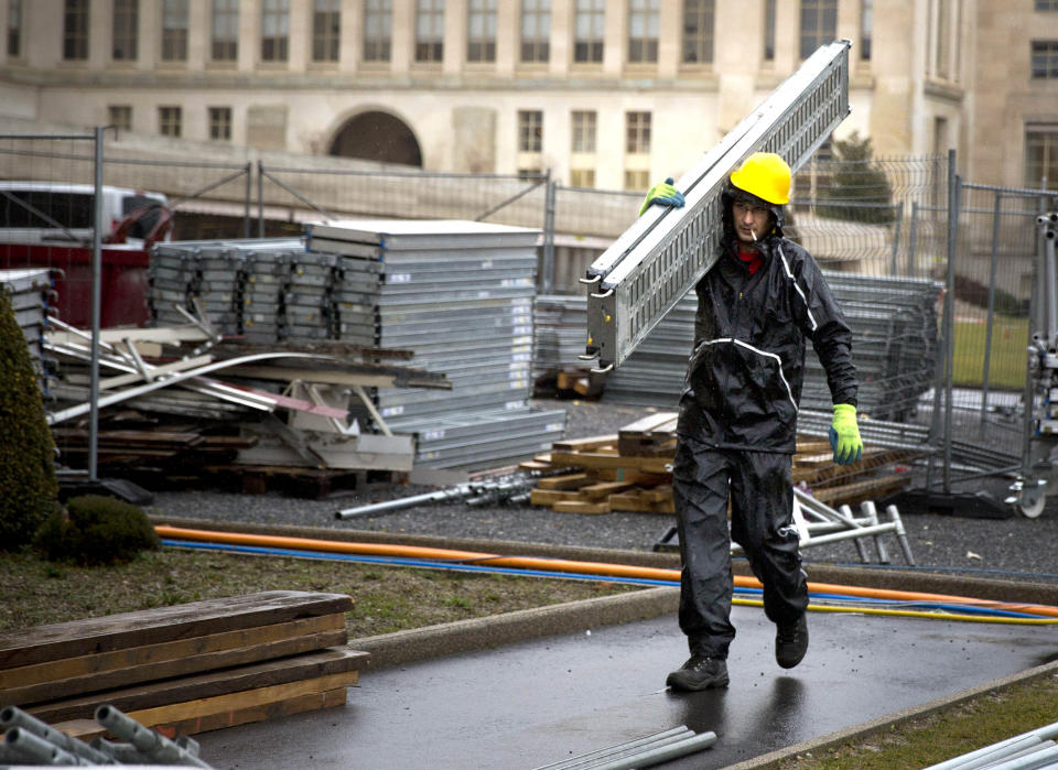 A Spanish construction worker carries equipment on a construction place at the United Nations European headquarters in Geneva, Switzerland, Monday, Feb. 10, 2014. The choice by Swiss voters to reimpose curbs on immigration is sending shockwaves throughout the European Union, with EU leaders on Monday warning the Swiss had violated the “sacred principle” of Europeans’ freedom of movement and politicians anxiously trying to gauge the vote’s impact on burgeoning anti-foreigner movements in other countries. (AP Photo/Anja Niedringhaus)