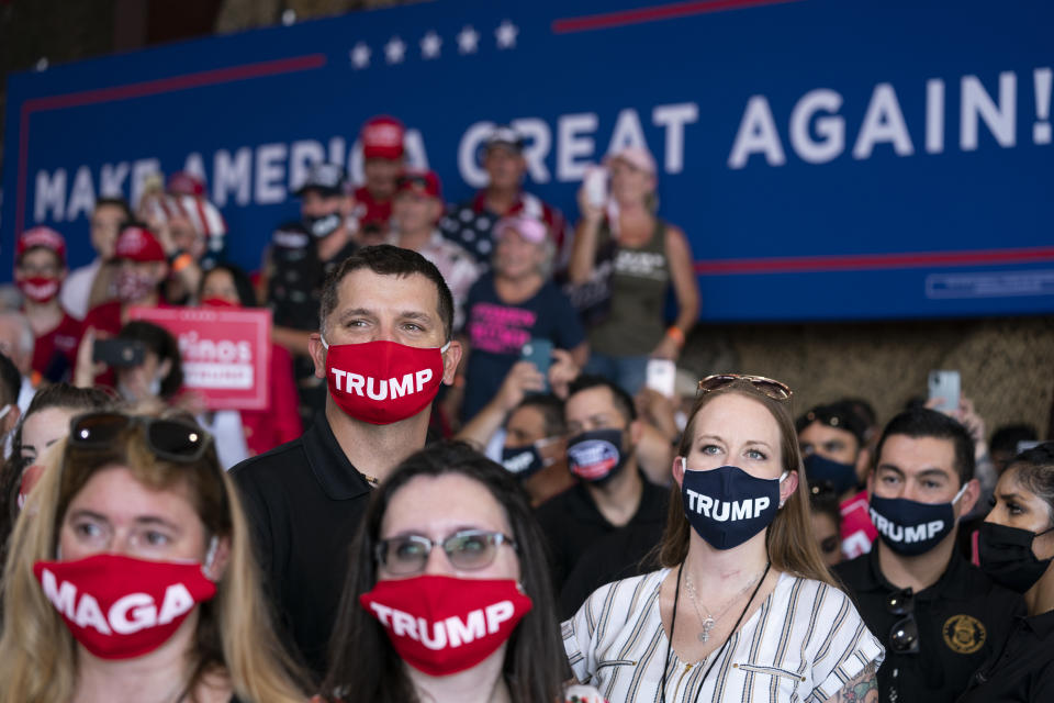 Supporters of President Donald Trump listen as he speaks at Yuma International Airport, Tuesday, Aug. 18, 2020, in Yuma, Ariz. (AP Photo/Evan Vucci)