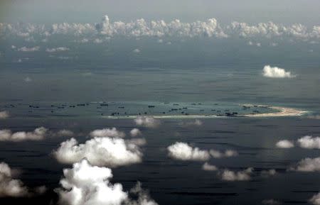 An aerial file photo taken though a glass window of a Philippine military plane shows the alleged on-going land reclamation by China on Mischief Reef in the Spratly Islands in the South China Sea, west of Palawan, Philippines in this May 11, 2015 file photo. REUTERS/Ritchie B. Tongo/Pool/Files