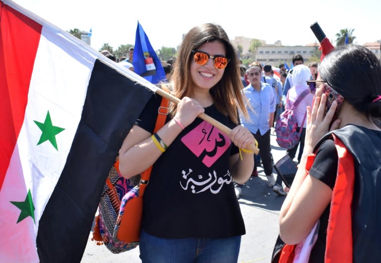 Syrians rally in Damascus' Umayyad square on April 16, 2018 in support of President Bashar al-Assad following Western air strikes against the regime over an alleged chemical attack