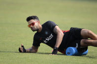 India cricket team captain Virat Kohli stretches during a practice session ahead of the Asia Cup tournament in Dhaka, Bangladesh, Monday, Feb. 24, 2014. Pakistan plays Sri Lanka in the opening match of the five nation one day cricket event that begins Tuesday. (AP Photo/A.M. Ahad)