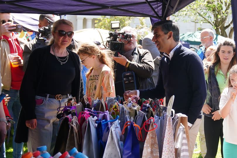 Prime Minister Rishi Sunak talikng to a person at a village fete in Great Ayton, Yorkshire while on the General Election campaign trail.