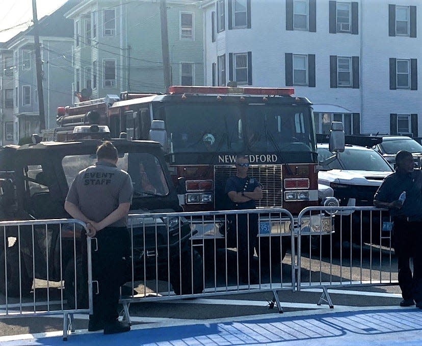 A New Bedford firefighter stands by on detail at the intersection of Hathaway Street and Madeira Avenue as the 107th Feast of the Blessed Sacrament began on Thursday, Aug. 3.
