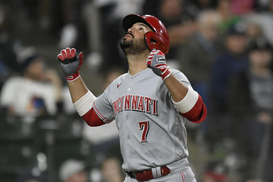 Cincinnati Reds' Eugenio Suarez (7) celebrates at home plate after hitting a solo home run during the fifth inning of a baseball game against the Chicago White Sox Tuesday, Sept. 28, 2021, in Chicago. (AP Photo/Paul Beaty)