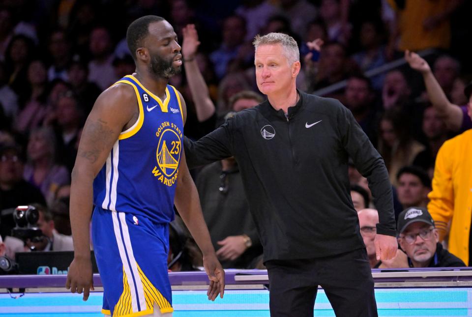 May 12, 2023; Los Angeles, California, USA; Golden State Warriors forward Draymond Green (23) walks past head coach Steve Kerr after fouling out in the second half of game six of the 2023 NBA playoffs at Crypto.com Arena.