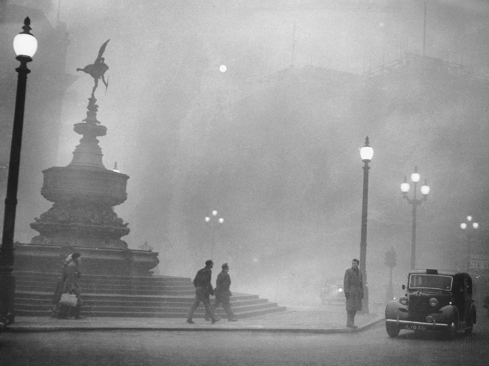 The Shaftesbury Memorial Fountain is covered by heavy smog in Piccadilly Circus, London, on December 6, 1952.