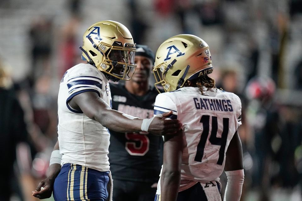 Akron quarterback DJ Irons, left, talks with wide receiver Jasaiah Gathings (14) following a four-overtime loss at Indiana, Saturday, Sept. 23, 2023, in Bloomington.
