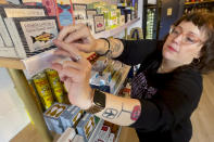 DECANTsf co-founder Cara Patricia restocks shelves of tinned fish inside the bar, Friday, Oct. 13, 2023, in San Francisco. (AP Photo/Haven Daley)