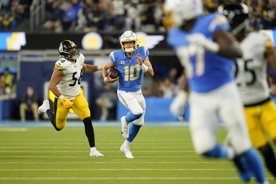 Los Angeles Chargers quarterback Justin Herbert (10) runs with the ball as Pittsburgh Steelers outside linebacker Alex Highsmith, left, defends during the second half of an NFL football game Sunday, Nov. 21, 2021, in Inglewood, Calif. (AP Photo/Marcio Jose Sanchez)