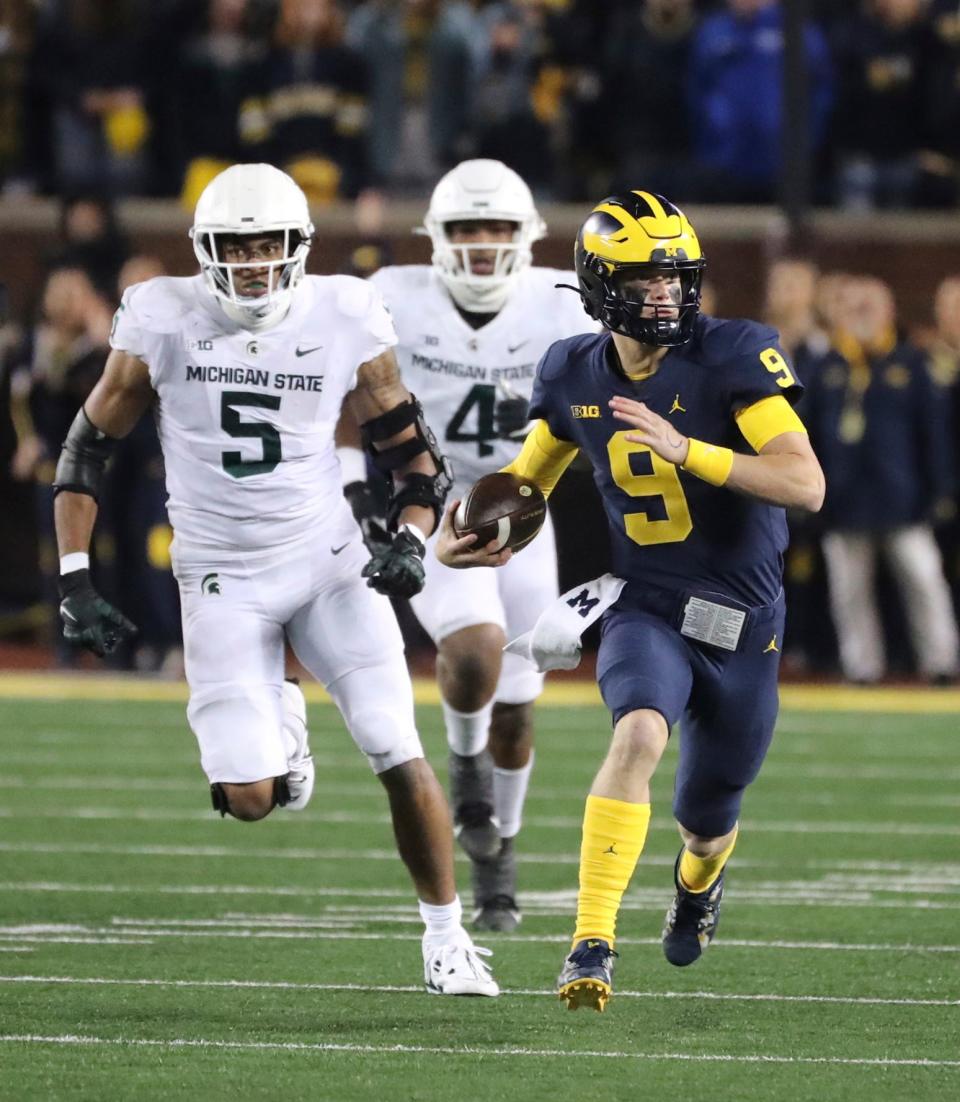 Michigan quarterback J.J. McCarthy runs by Michigan State defensive end Michael Fletcher during the first half half on Saturday, October 29, 2022, in Ann Arbor.