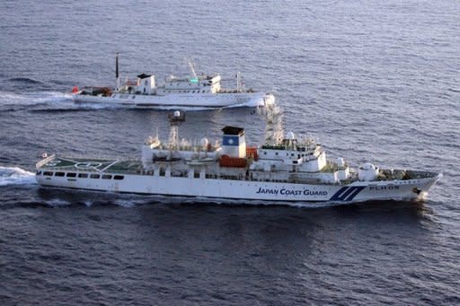 A Japan coast guard vessel (bottom) monitors a Chinese fisheries boat (top) near the disputed Senkaku or Diaoyu islands in August 2011.Japan protested to China on Wednesday as a new diplomatic row flared over a remote chain of islands, with Beijing asserting its "indisputable sovereignty" over the uninhabited territories