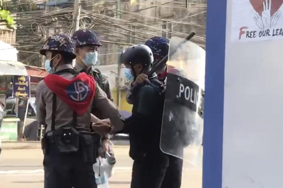 FILE - In this file image made from video taken on Feb. 27, 2021, Associated Press journalist Thein Zaw is arrested by police in Yangon, Myanmar. A court in Myanmar extended on Friday, March 12, 2021, the pretrial detention of an Associated Press journalist who was arrested while covering demonstrations against a coup. He is facing a charge that could send him to prison for three years. His next hearing will be on March 24. (AP Photo/File)