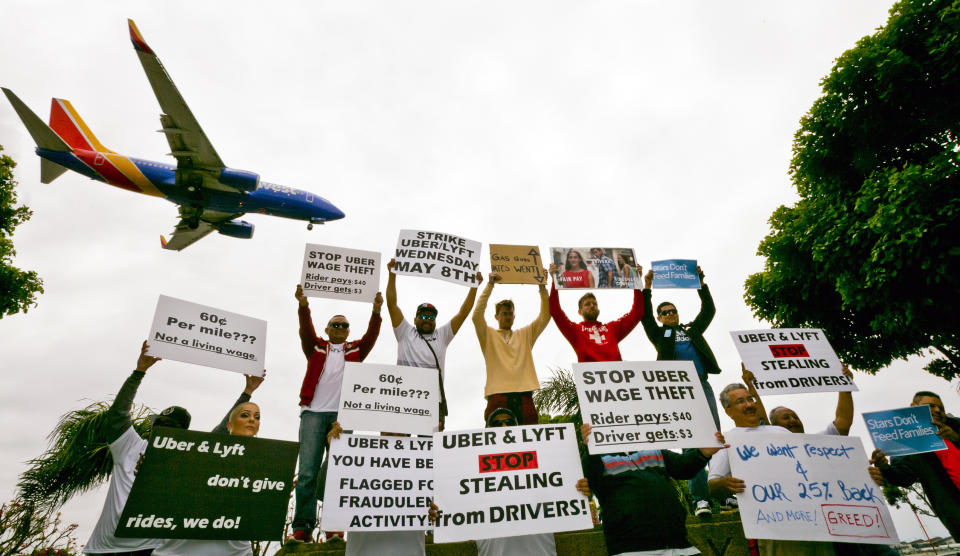 <p>Drivers for ride-hailing giants Uber and Lyft hold a rally at a park near Los Angeles International Airport, Wednesday, May, 8, 2019, in Los Angeles. Some drivers for ride-hailing giants Uber and Lyft turned off their apps to protest what they say are declining wages as both companies rake in billions of dollars from investors. (AP Photo/Damian Dovarganes) </p>