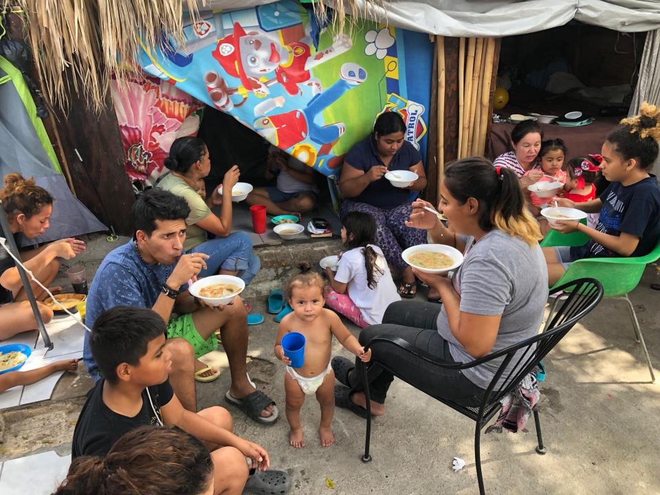 Families of migrants eat lunch in front of makeshift bunkers at a shelter in Nuevo Laredo, Mexico, across the border from Laredo, Texas. Many of the families never leave the shelter for fear of being targeted by cartels.