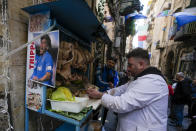 A photo of Diego Armando Maradona is seen next to a butchers stall in downtown Naples, Italy, Wednesday, April 19, 2023. It's a celebration more than 30 years in the making, and historically superstitious Napoli fans are already painting the city blue in anticipation of the team's first Italian league title since the days when Diego Maradona played for the club. (AP Photo/Andrew Medichini)