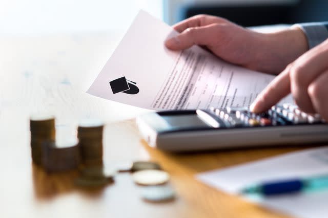 <p>Getty Images, Tero Vesalainen</p> Stock image of person calculating college tuition