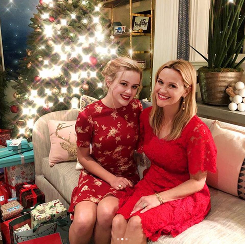The ladies in red were shining just as bright as their Christmas tree.