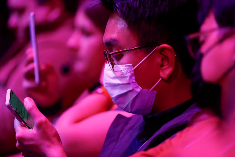 FILE PHOTO: An attendee wears a surgical mask during Samsung Galaxy Unpacked 2020 in San Francisco