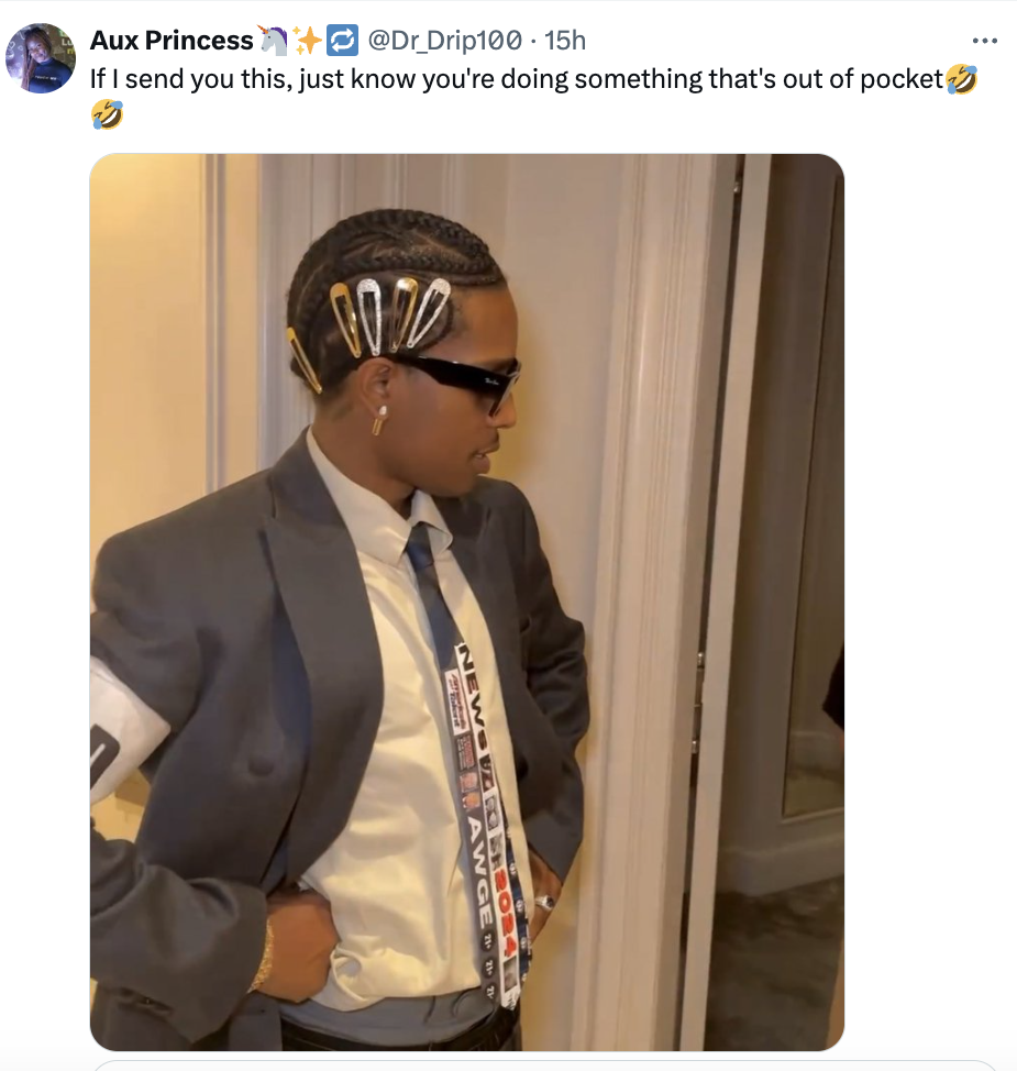A person in a suit with hair clips and a necktie stands in a hallway, wearing sunglasses. Tweet text above reads, "If I send you this, just know you're doing something that's out of pocket."