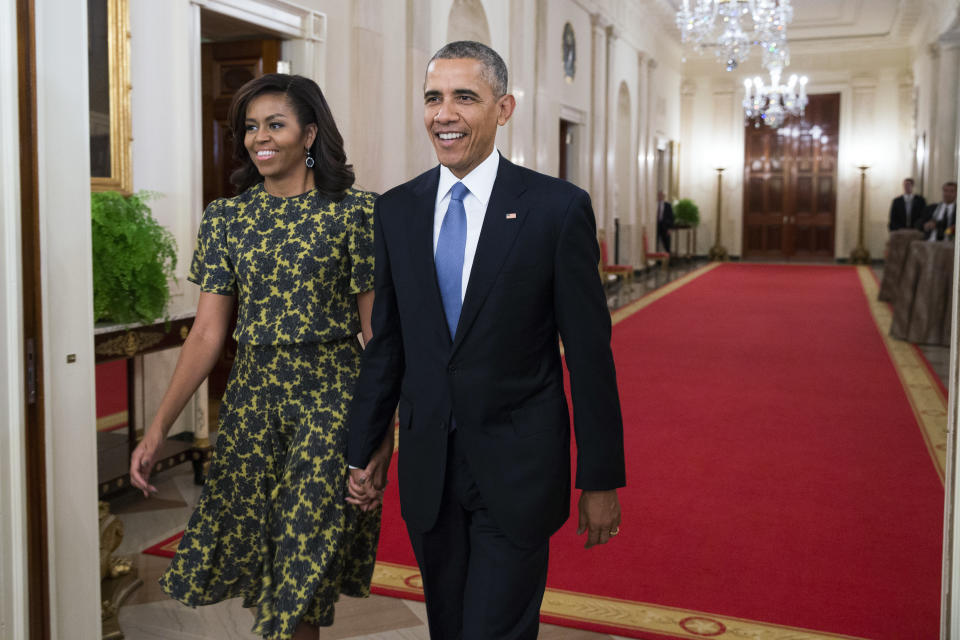 FILE - First lady Michelle Obama, and President Barack Obama arrive for the Presidential Medal of Freedom ceremony in the East Room of the White House, on Tuesday, Nov. 24, 2015, in Washington. Former President Barack Obama's presidential portrait will be unveiled at the White House in a Sept. 7, 2022, ceremony hosted by President Joe Biden. (AP Photo/Evan Vucci, File)