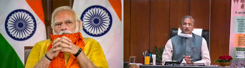 **EDS: SCREENSHOT FROM VIDEO STREAM** New Delhi: Prime Minister Narendra Modi during inauguration of six mega projects in Uttarakhand under the Namami Gange Mission through a video conference, New Delhi, Tuesday, Sept. 29, 2020. Uttarakhand CM Trivendra Singh Rawat is also seen. (PTI Photo) (PTI29-09-2020_000023B)