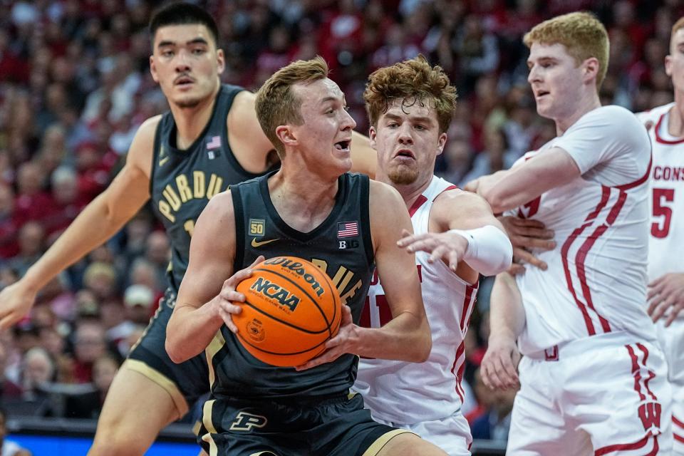 Purdue's Fletcher Loyer (2) drives against Wisconsin's Max Klesmit, behind, during the first half of an NCAA college basketball game Thursday, March 2, 2023, in Madison, Wis. (AP Photo/Andy Manis)
