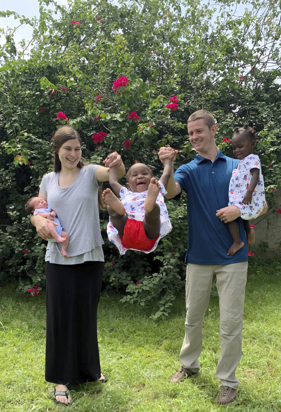 This Sept. 21, 2019 family photo shows Michaela Parker holding her newborn son, Philip; adopted twin daughters Ariella, center, and Claira, right, and father, David Parker, in N'Djamena, Chad. Amid the 2020 coronavirus outbreak, the Parkers are stranded in Yaounde, Cameroon, waiting for the U.S. embassy to issue visas for the twin girls they adopted in Chad in November 2018. (Courtesy David Parker via AP)