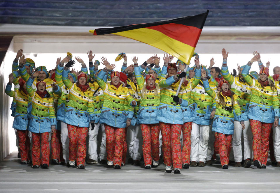 Maria Hoefl-Riesch of Germany carries the national flag as she leads the team during the opening ceremony of the 2014 Winter Olympics in Sochi, Russia, Friday, Feb. 7, 2014. (AP Photo/Mark Humphrey)