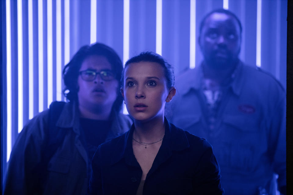 This image released by Warner Bros. Entertainment shows Millie Bobby Brown, center, Julian Dennison, left, and Brian Tyree Henry in a scene from "Godzilla vs. Kong." (Warner Bros. Entertainment via AP)