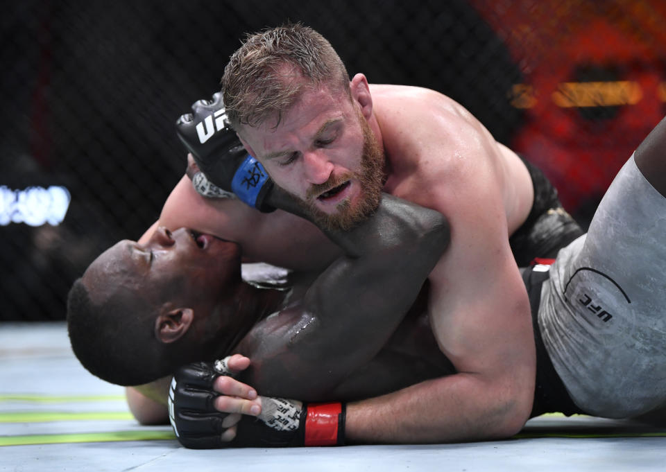 LAS VEGAS, NEVADA - MARCH 06: (R-L) Jan Blachowicz of Poland controls Israel Adesanya of Nigeria on the ground in their UFC light heavyweight championship fight during the UFC 259 event at UFC APEX on March 06, 2021 in Las Vegas, Nevada. (Photo by Chris Unger/Zuffa LLC)