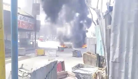 Debris burn on a street in Mogadishu, Somalia April 13, 2019 in this still image taken from a video obtained on social media. Wadani Xasan Cade via REUTERS