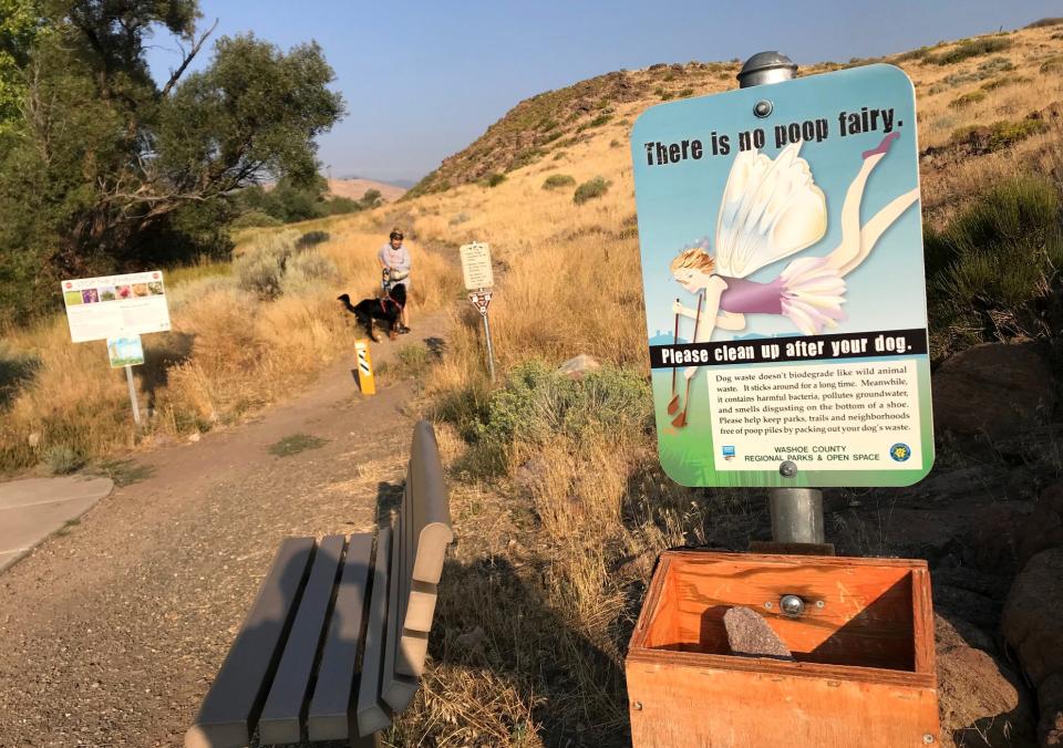 A sign asking people to clean up their dog's poop is seen at the Ballardini Ranch Trailhead in Reno.