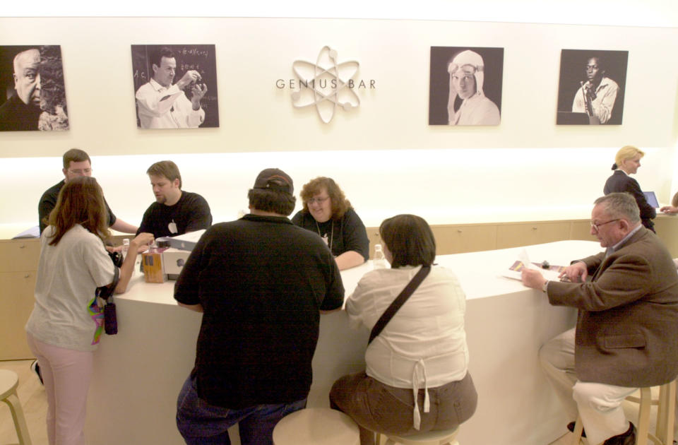 Photo of people sitting at a Genius Bar