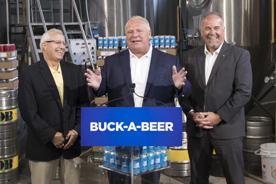 Ontario Premier Doug Ford announces his buck-a-beer policy with ministers Vic Fedeli and Todd Smith at Barley Days Brewery in Picton, Ont. on Aug. 7, 2018. (The Canadian Press)