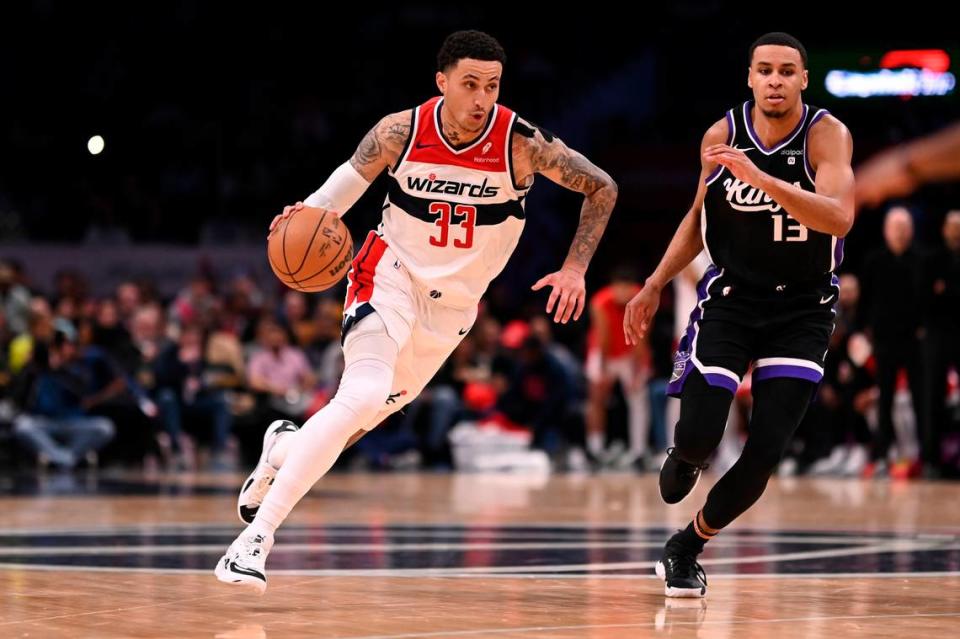 Washington Wizards forward Kyle Kuzma (33) drives to the basket as Sacramento Kings forward Keegan Murray (13) defends during the second half Thursday, March 21, 2024, at Capital One Arena in Washington, D.C.